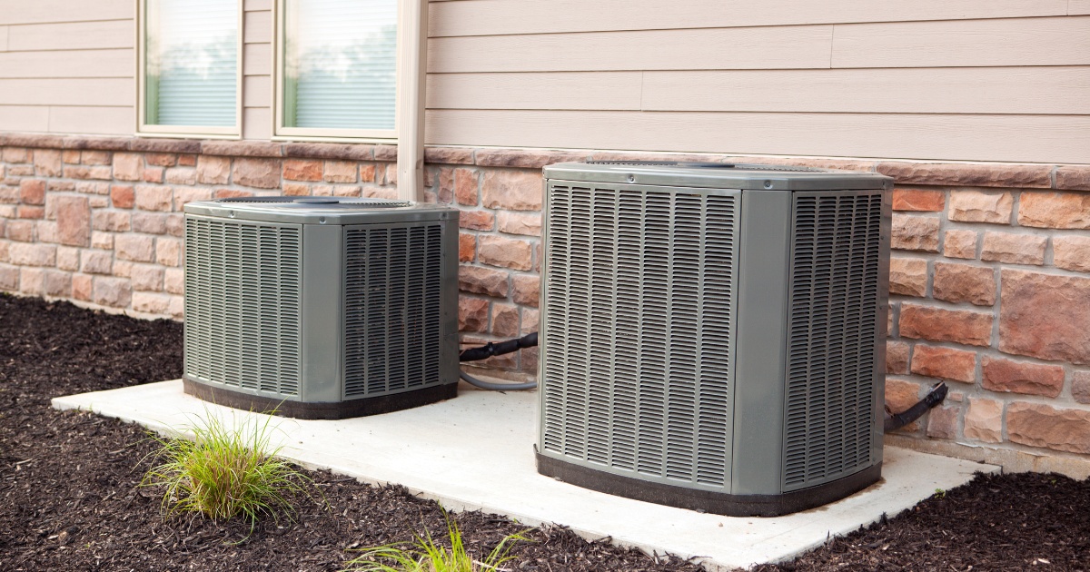 2 air conditioner condensers on a concrete pad